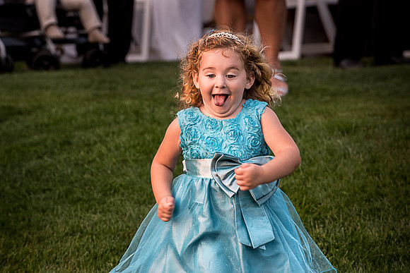 Kid running at a wedding